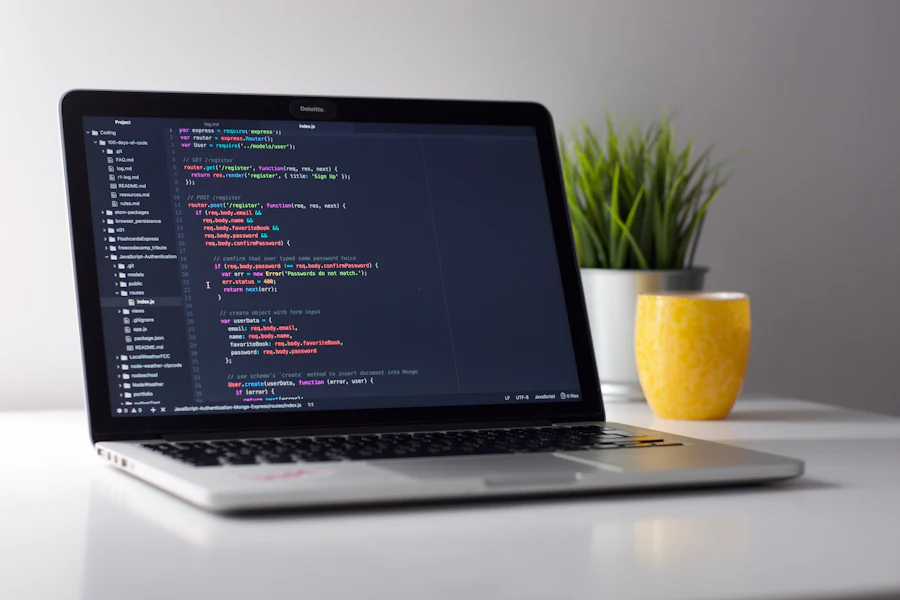 Laptop displaying application source code in a code editor on a clean desk